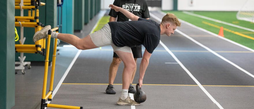 Athlete training with kettle bell